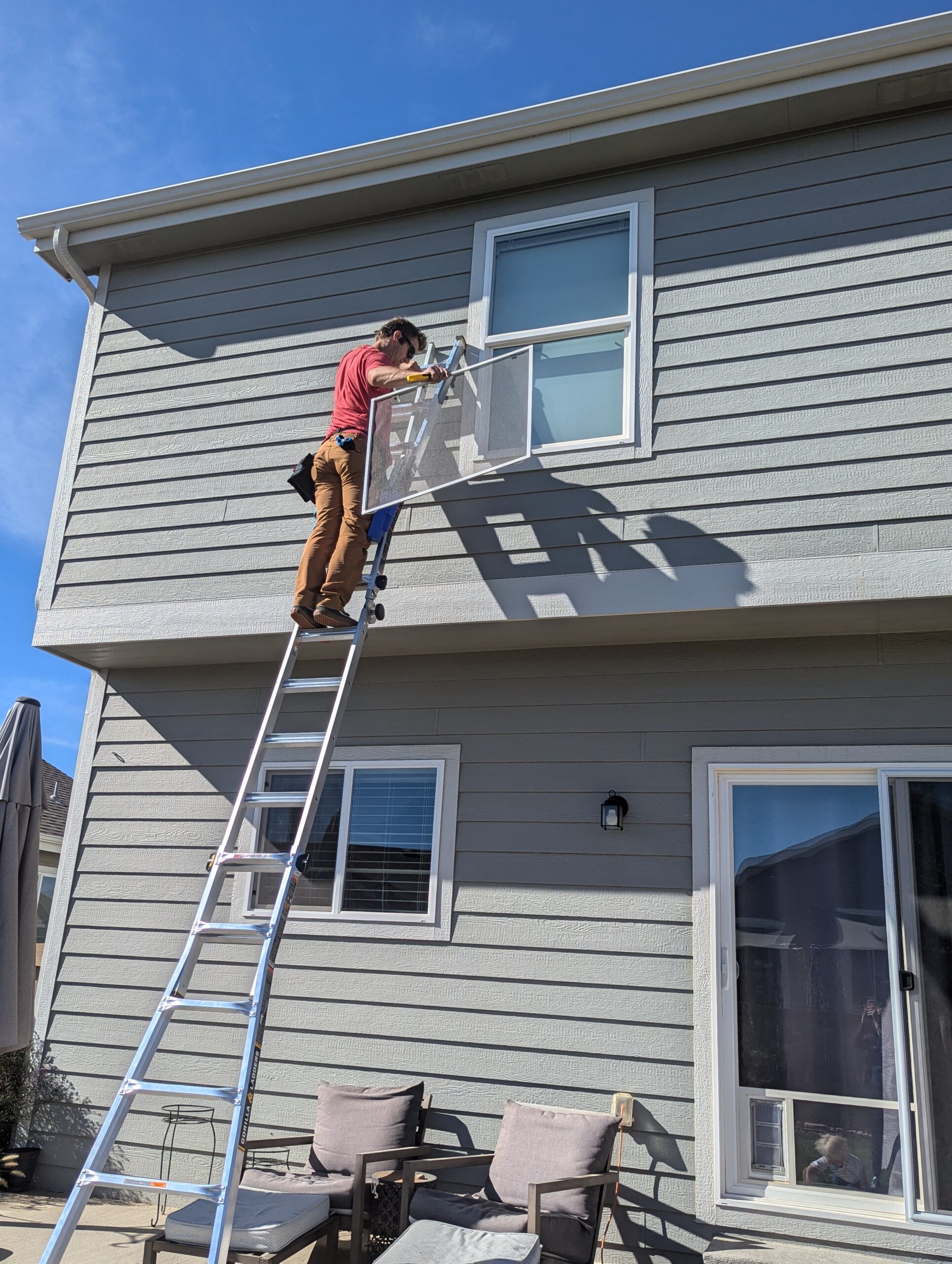 Professional window cleaning in Northern Colorado using a water-fed pole to safely clean second-story windows.